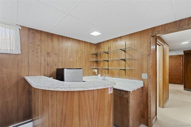 5960 Glencoe St, Commerce City, CO 80022 - indoor bar with baseboard heating, wood walls, light carpet, and a paneled ceiling
