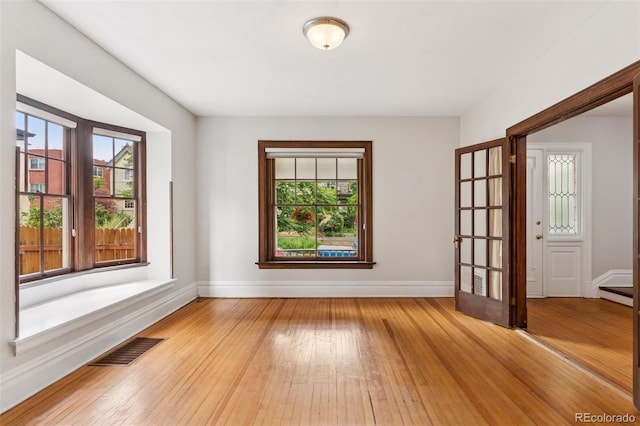 1352 N Downing St, Denver, CO 80218 - empty room featuring healthy amount of natural light and light wood-style flooring