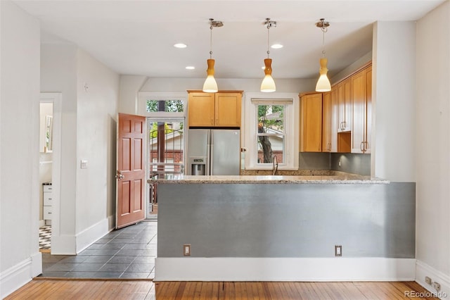 1352 N Downing St, Denver, CO 80218 - kitchen featuring stainless steel refrigerator with ice dispenser, a peninsula, dark wood-style floors, light stone countertops, and recessed lighting