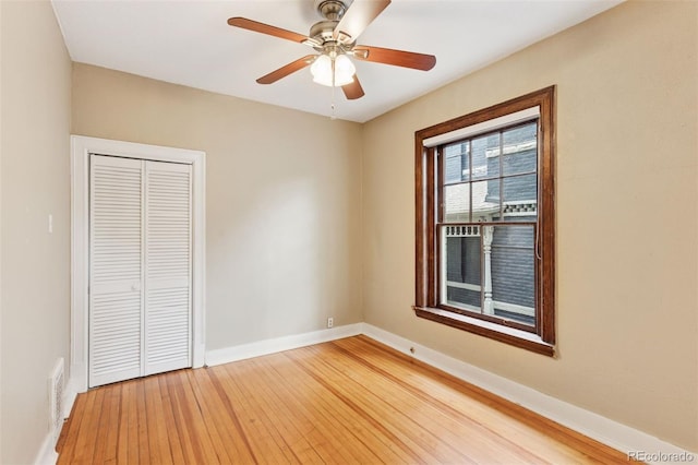 1352 N Downing St, Denver, CO 80218 - unfurnished bedroom with light wood-style flooring, a closet, and ceiling fan