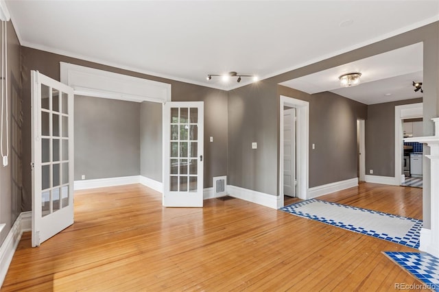1352 N Downing St, Denver, CO 80218 - empty room featuring french doors, light wood-type flooring, and a fireplace