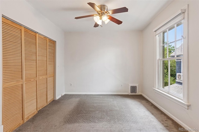 1352 N Downing St, Denver, CO 80218 - unfurnished bedroom featuring multiple windows, carpet, and a closet