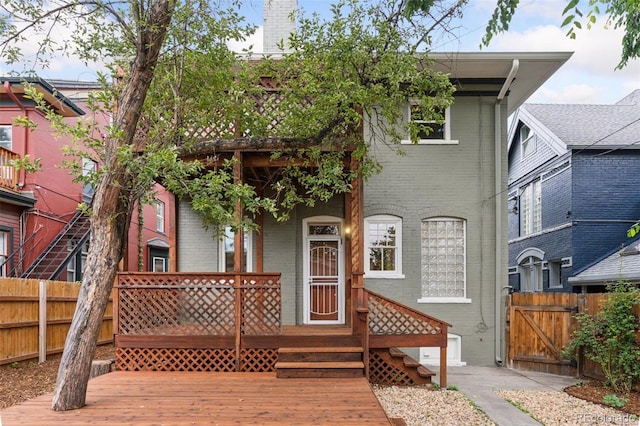 1352 N Downing St, Denver, CO 80218 - view of front facade featuring brick siding, a gate, and a porch