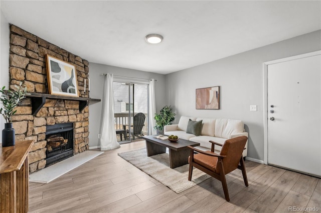 13333 E Asbury Dr Unit 104, Aurora, CO 80014 - living room with wood finished floors, a stone fireplace, and baseboards