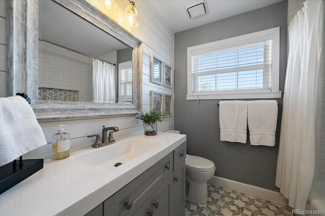 bathroom featuring toilet, tile patterned flooring, walk in shower, and vanity