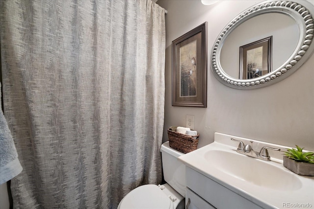 bathroom featuring vanity and toilet