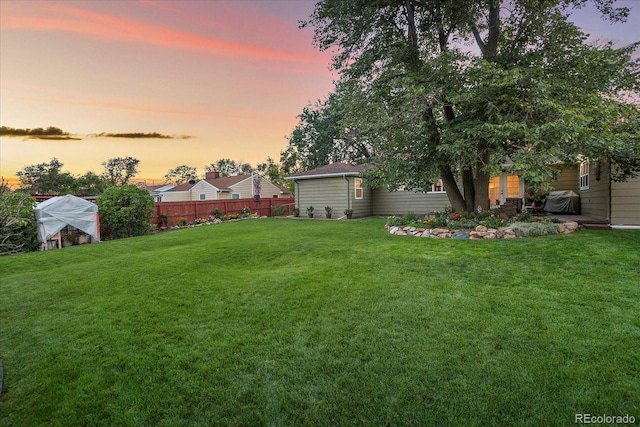 view of yard at dusk