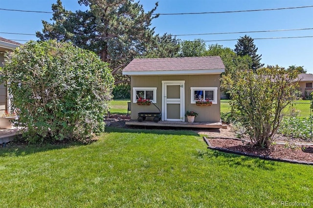 view of outbuilding with a yard