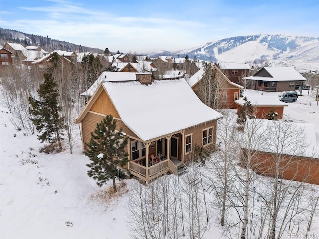 snowy aerial view featuring a mountain view