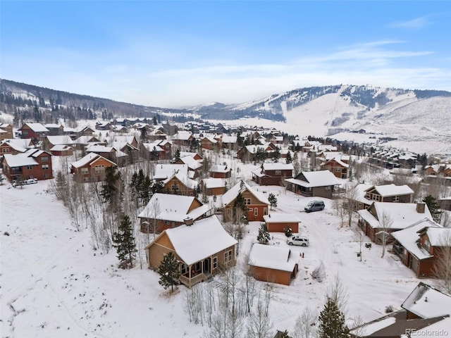 snowy aerial view with a mountain view