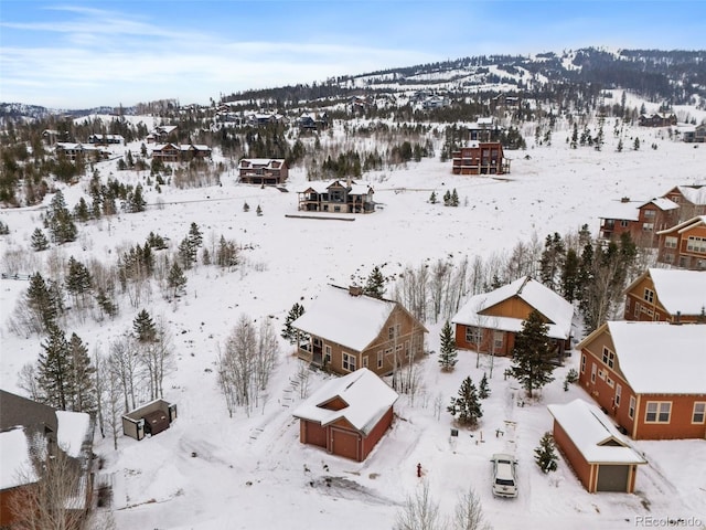 snowy aerial view with a mountain view