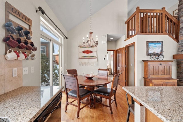 112 Deer Track Ct, Granby, CO 80446 - dining area featuring light wood finished floors, high vaulted ceiling, and a chandelier