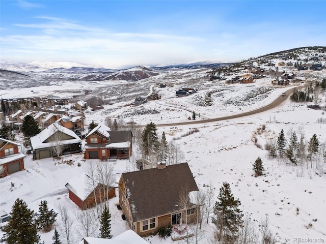 snowy aerial view featuring a mountain view