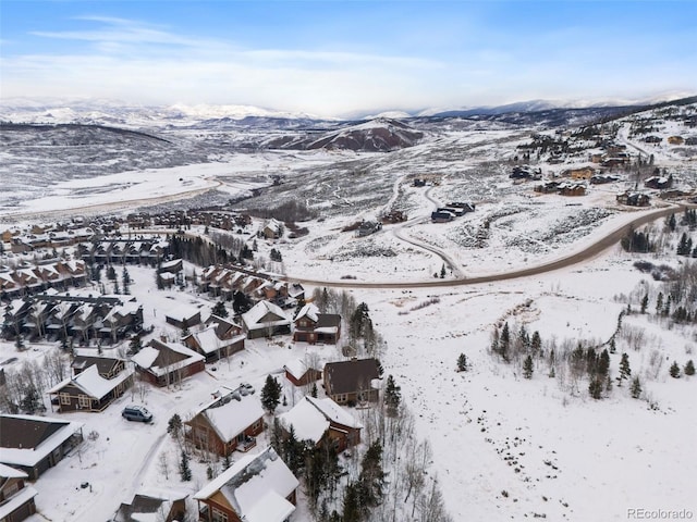 snowy aerial view with a mountain view