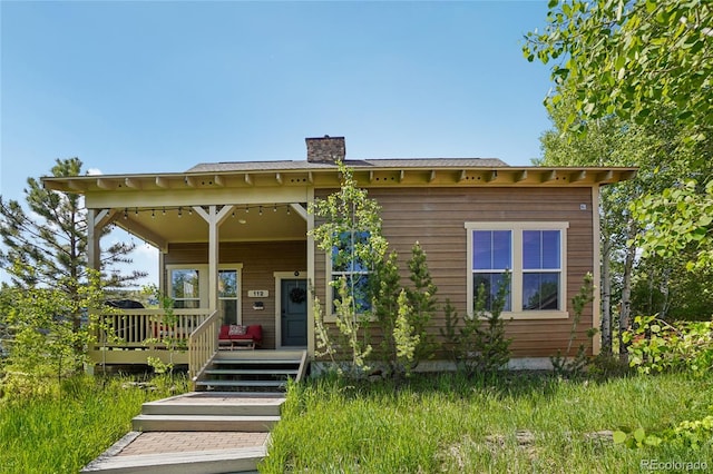 112 Deer Track Ct, Granby, CO 80446 - view of front of house featuring a chimney and a porch