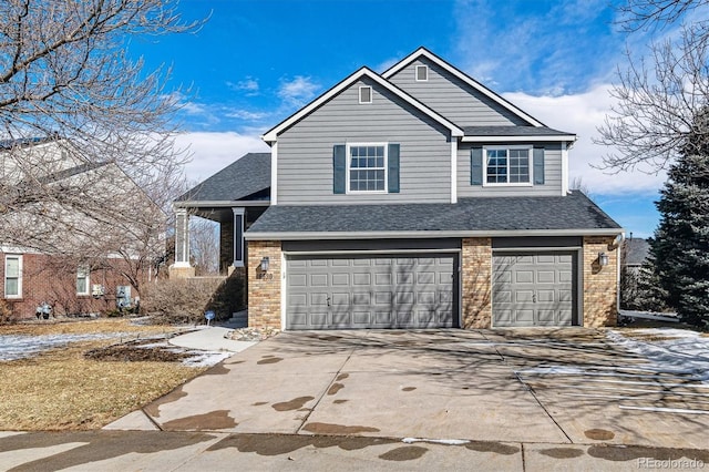 view of front of home with an attached garage, a shingled roof, concrete driveway, and brick siding