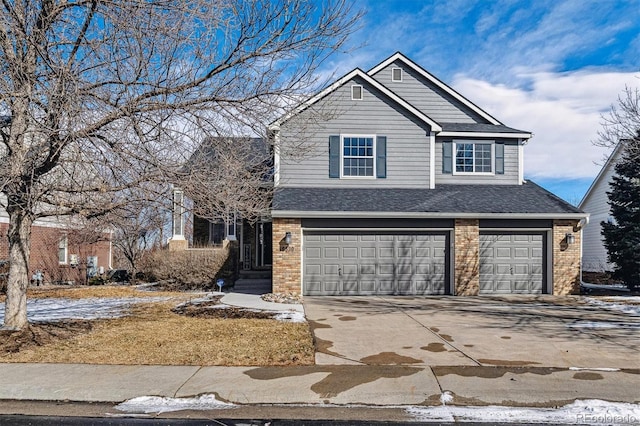 view of front facade featuring an attached garage, driveway, a shingled roof, and brick siding