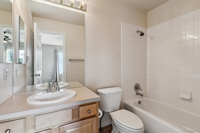 bathroom featuring toilet, shower / washtub combination, a ceiling fan, and vanity