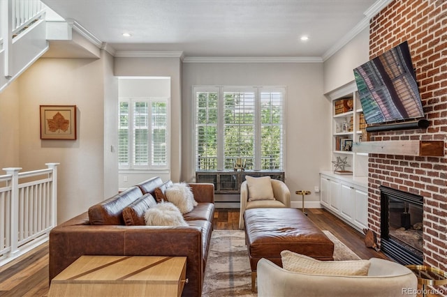 living room featuring ornamental molding, dark hardwood / wood-style floors, and a brick fireplace