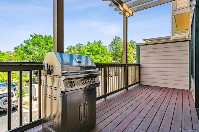 wooden terrace featuring a pergola and a grill