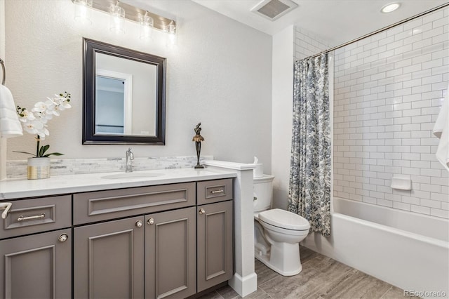 full bathroom with hardwood / wood-style floors, vanity, toilet, and shower / bathtub combination with curtain