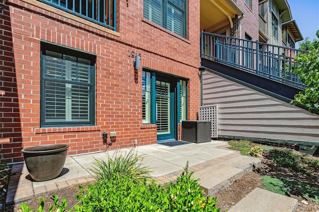 entrance to property with a patio