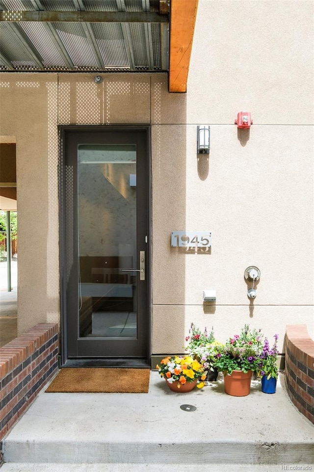 doorway to property with stucco siding