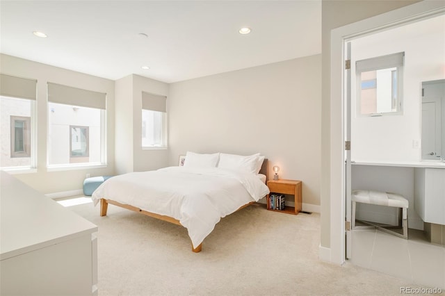bedroom with light colored carpet, recessed lighting, and baseboards
