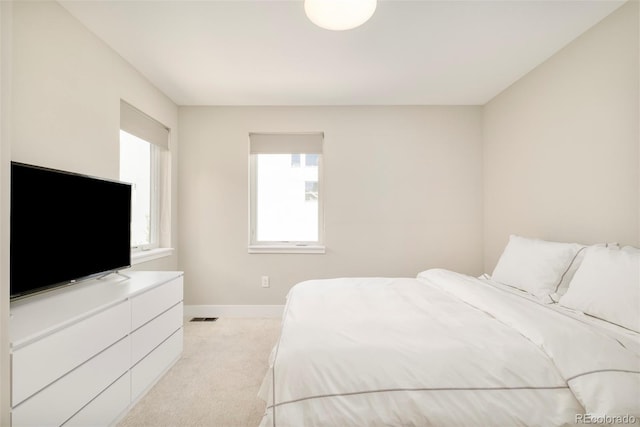 carpeted bedroom with baseboards and visible vents