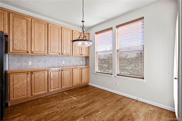 kitchen featuring decorative light fixtures, dark hardwood / wood-style floors, and decorative backsplash