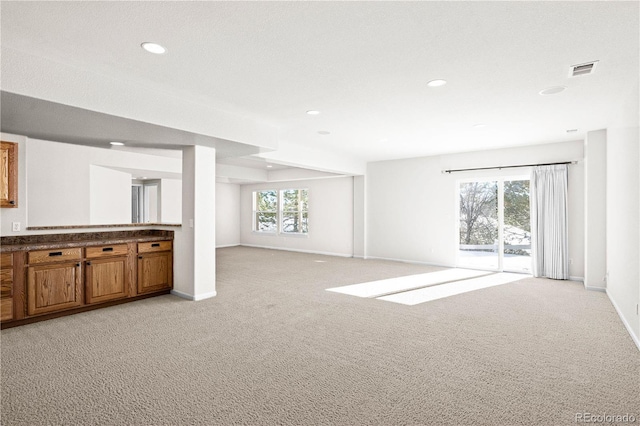 unfurnished living room featuring light colored carpet