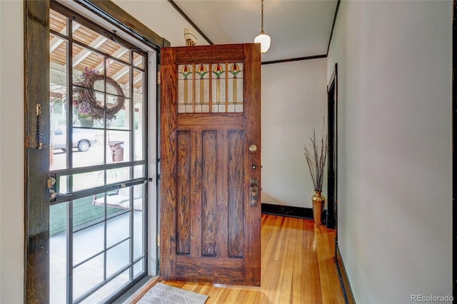 114 Cave Ave, Manitou Springs, CO 80829 - foyer entrance featuring wood finished floors, plenty of natural light, baseboards, and crown molding