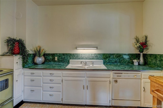 114 Cave Ave, Manitou Springs, CO 80829 - kitchen with dishwasher, a sink, range with electric cooktop, dark countertops, and white cabinets
