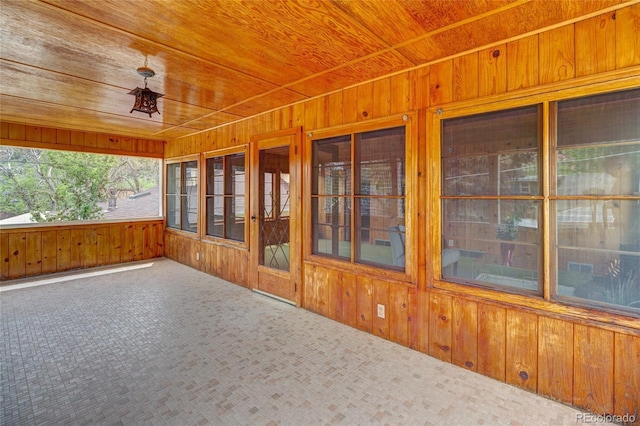 114 Cave Ave, Manitou Springs, CO 80829 - unfurnished sunroom featuring wood walls, wood ceiling, and carpet flooring
