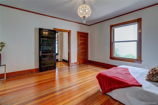 114 Cave Ave, Manitou Springs, CO 80829 - bedroom featuring light wood-style flooring, crown molding, a chandelier, and baseboards