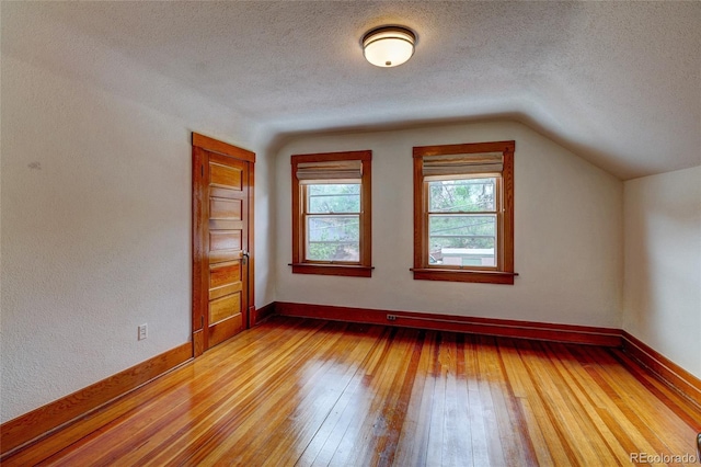 114 Cave Ave, Manitou Springs, CO 80829 - bonus room featuring light wood-type flooring, lofted ceiling, a textured ceiling, and baseboards
