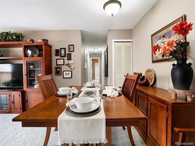 dining area featuring a textured ceiling