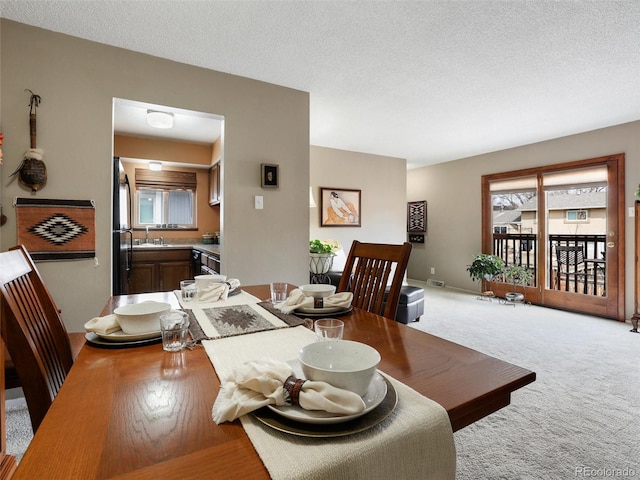 dining room featuring visible vents, baseboards, carpet, and a textured ceiling