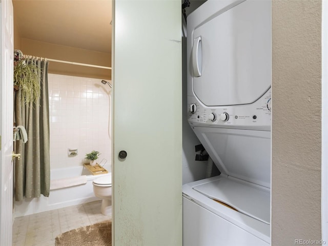 laundry area featuring laundry area and stacked washer / drying machine