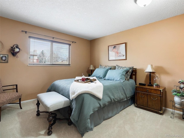 bedroom with baseboards, light colored carpet, and a textured ceiling