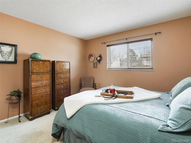 bedroom with light carpet, a textured ceiling, and baseboards