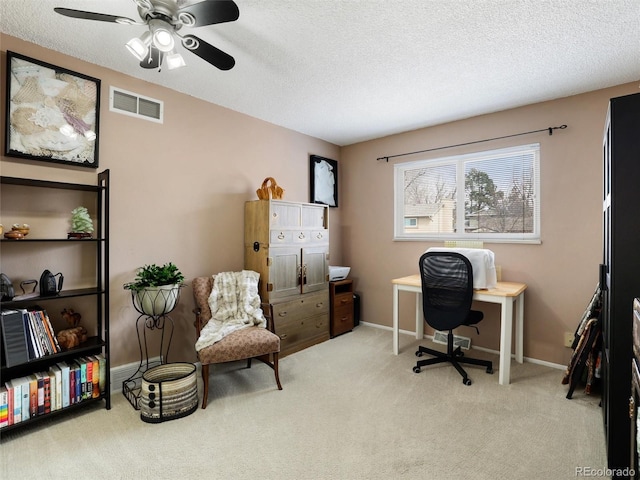 carpeted office space with visible vents, baseboards, and a textured ceiling