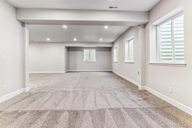 interior space featuring a wealth of natural light and light colored carpet