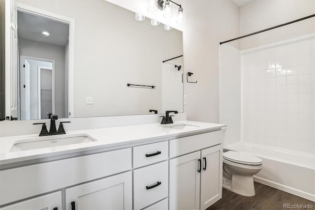 full bathroom with toilet, vanity, shower / bathtub combination, and hardwood / wood-style flooring