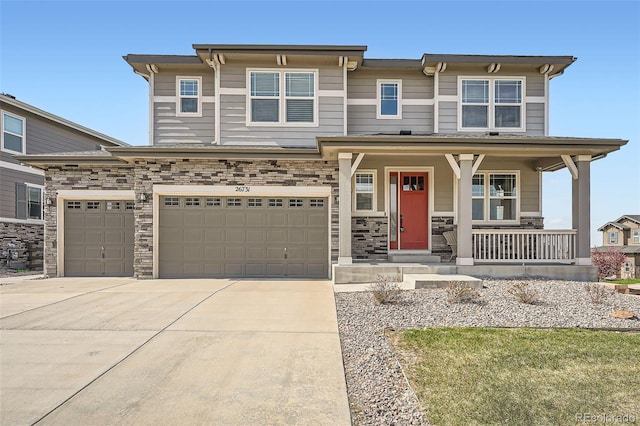 26731 E Hinsdale Pl, Aurora, CO 80016 - view of front of home featuring covered porch, an attached garage, driveway, and stone siding