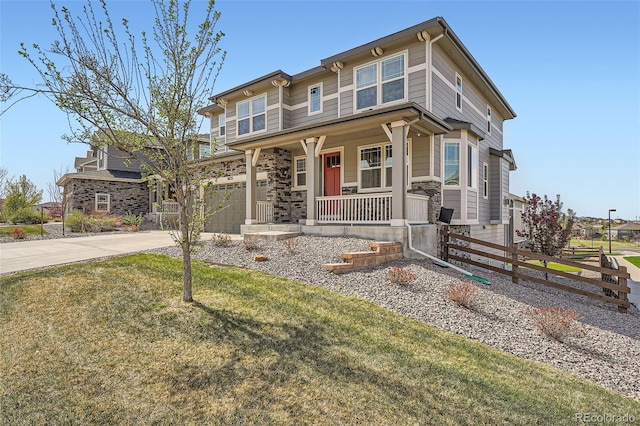 26731 E Hinsdale Pl, Aurora, CO 80016 - craftsman house featuring a porch, a garage, fence, a front lawn, and concrete driveway