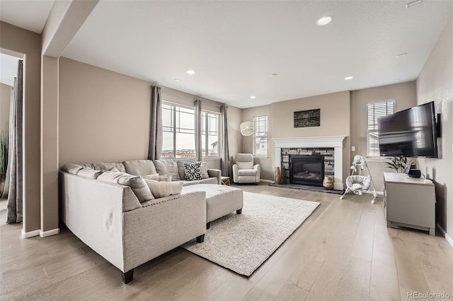 26731 E Hinsdale Pl, Aurora, CO 80016 - living room with light wood-style floors, recessed lighting, baseboards, and a stone fireplace