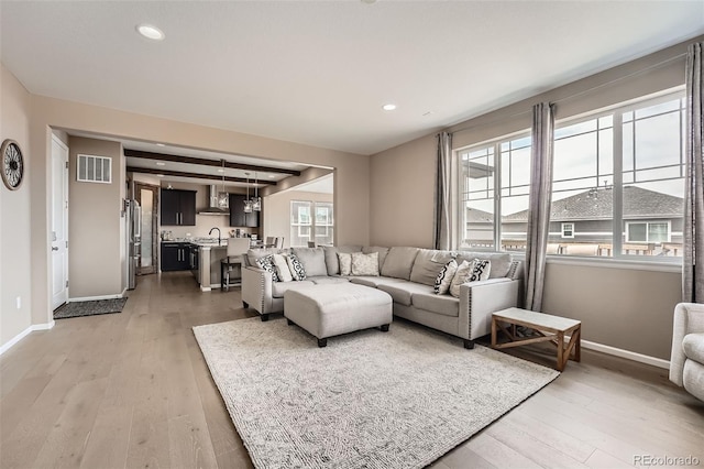 26731 E Hinsdale Pl, Aurora, CO 80016 - living area featuring recessed lighting, baseboards, light wood finished floors, and visible vents