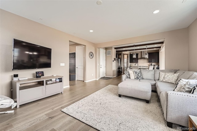 26731 E Hinsdale Pl, Aurora, CO 80016 - living room featuring baseboards, recessed lighting, and wood finished floors