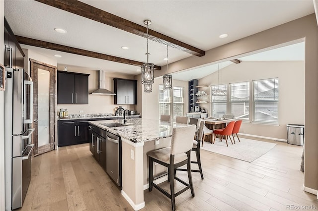 26731 E Hinsdale Pl, Aurora, CO 80016 - kitchen with wall chimney range hood, a breakfast bar area, appliances with stainless steel finishes, baseboards, and light wood finished floors